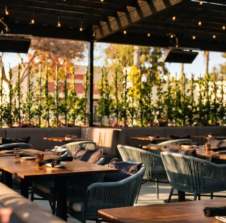 The Chicken Koop Downey Patio daytime seating with greenery